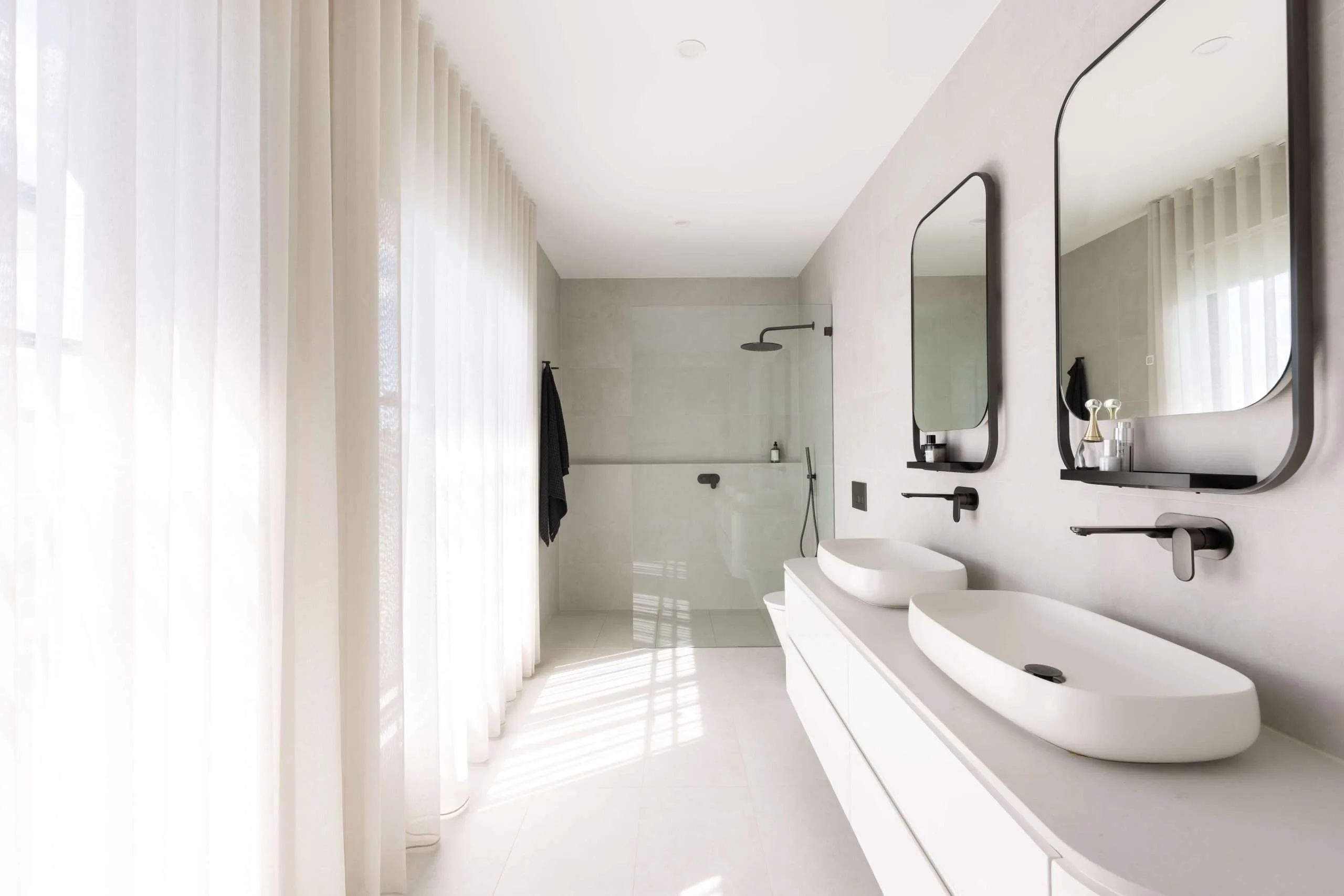 Ensuite with twin vessel basins and floor-to-ceiling tiling, Kellyville home