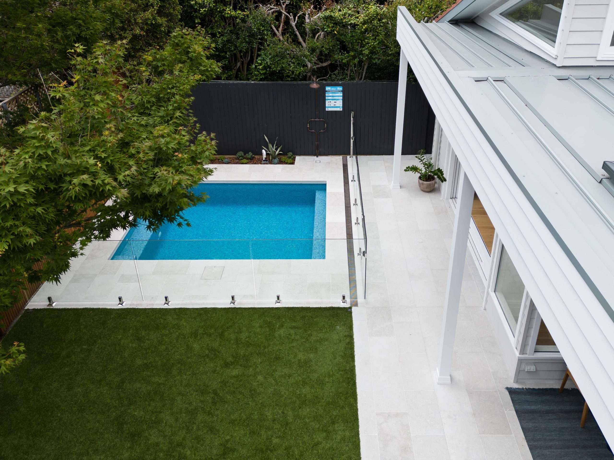 Fully tiled pool with white stone coping and turf surround, Mosman landscape