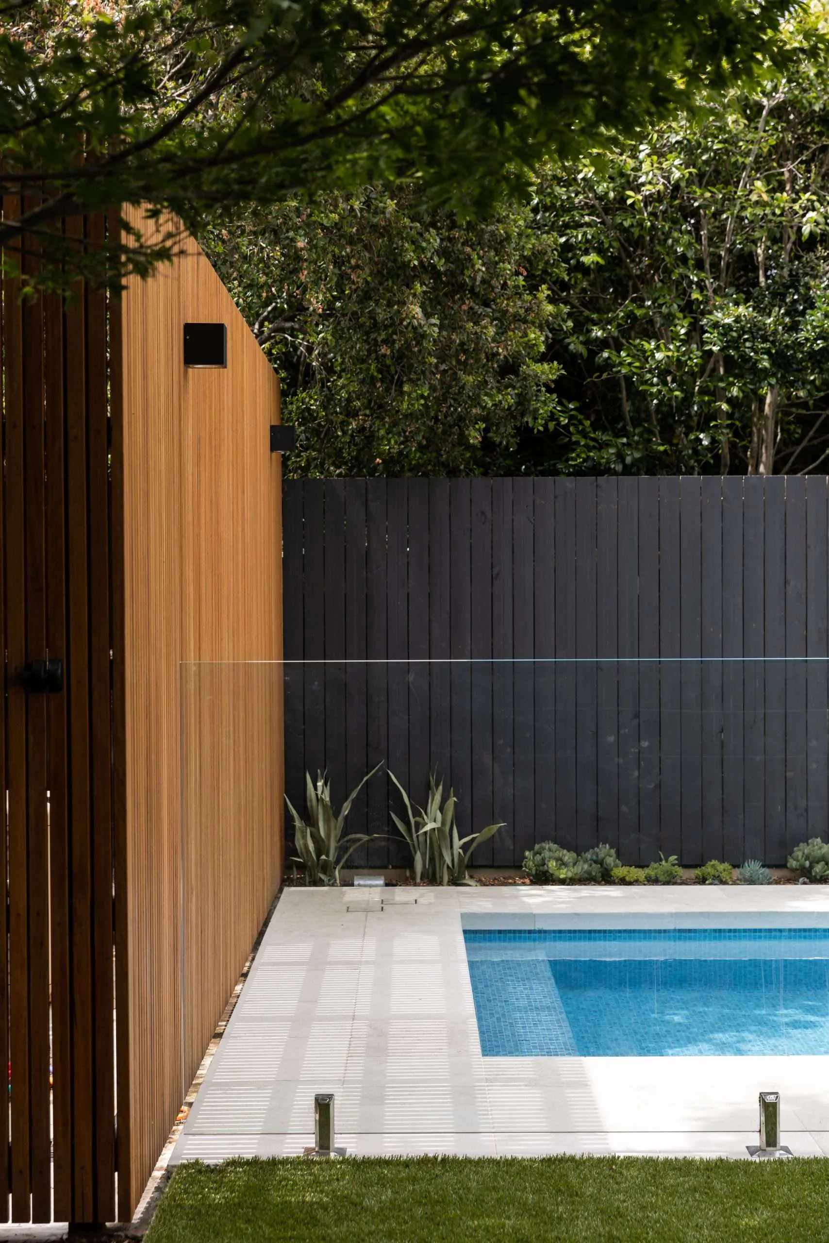 Timber batten gate detail against black boundary fencing, Mosman project