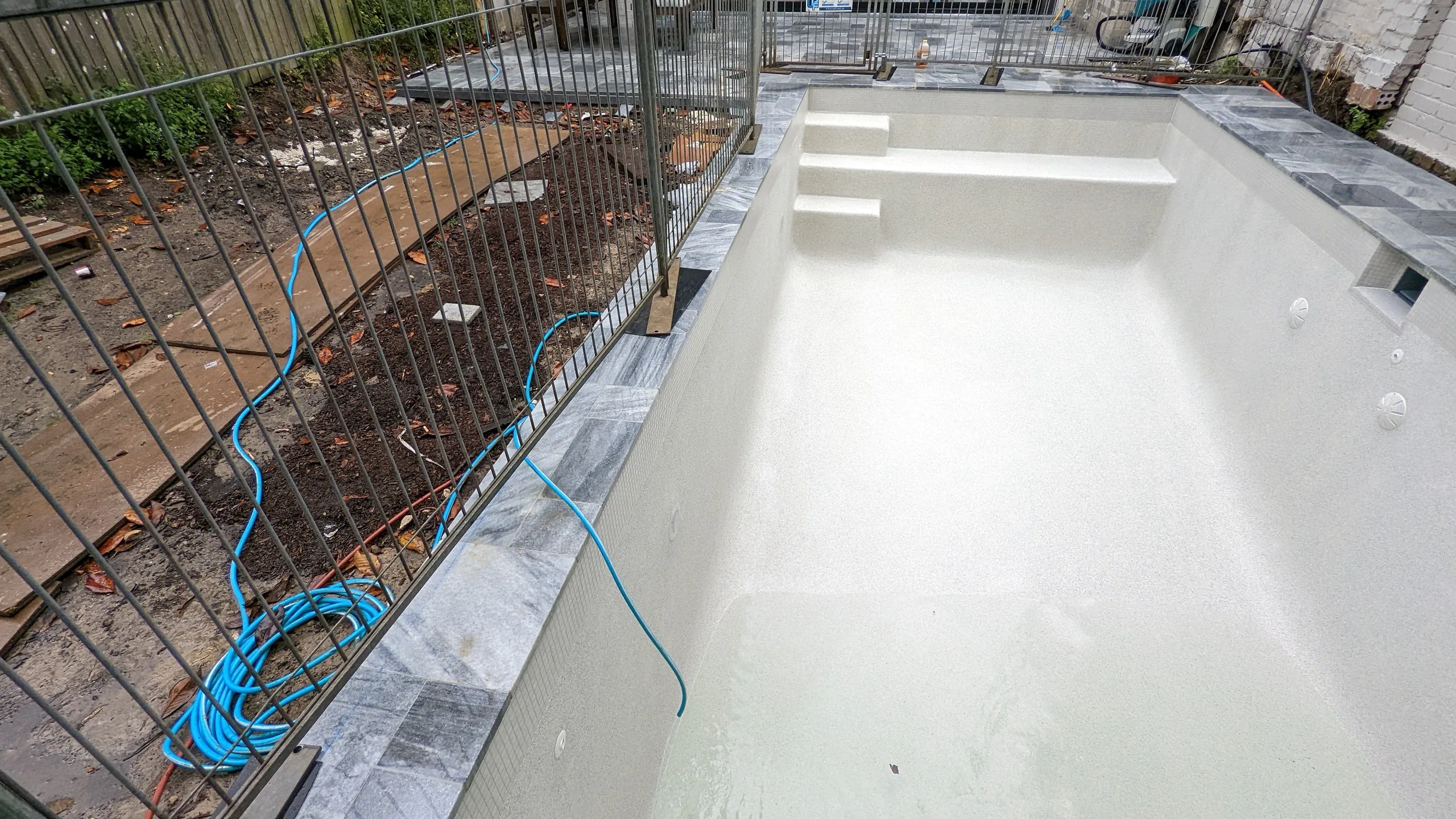 Waterline tiles, marble coping and beadcrete interior going in, Balmain
