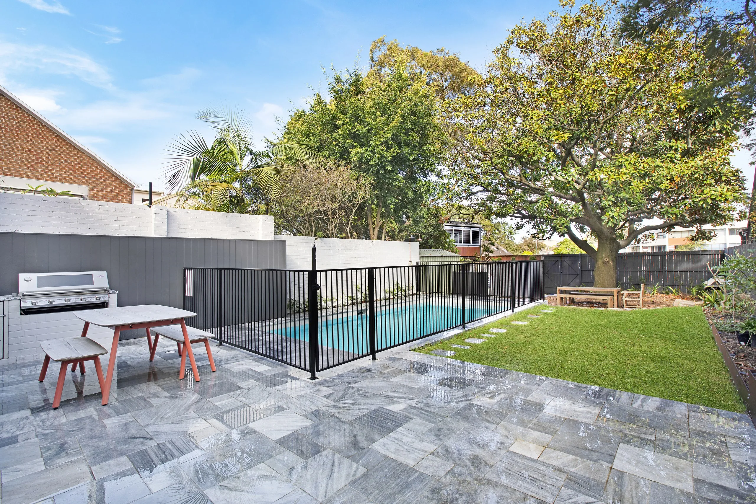 Marble paved BBQ terrace beside the pool and lawn, Balmain pool project