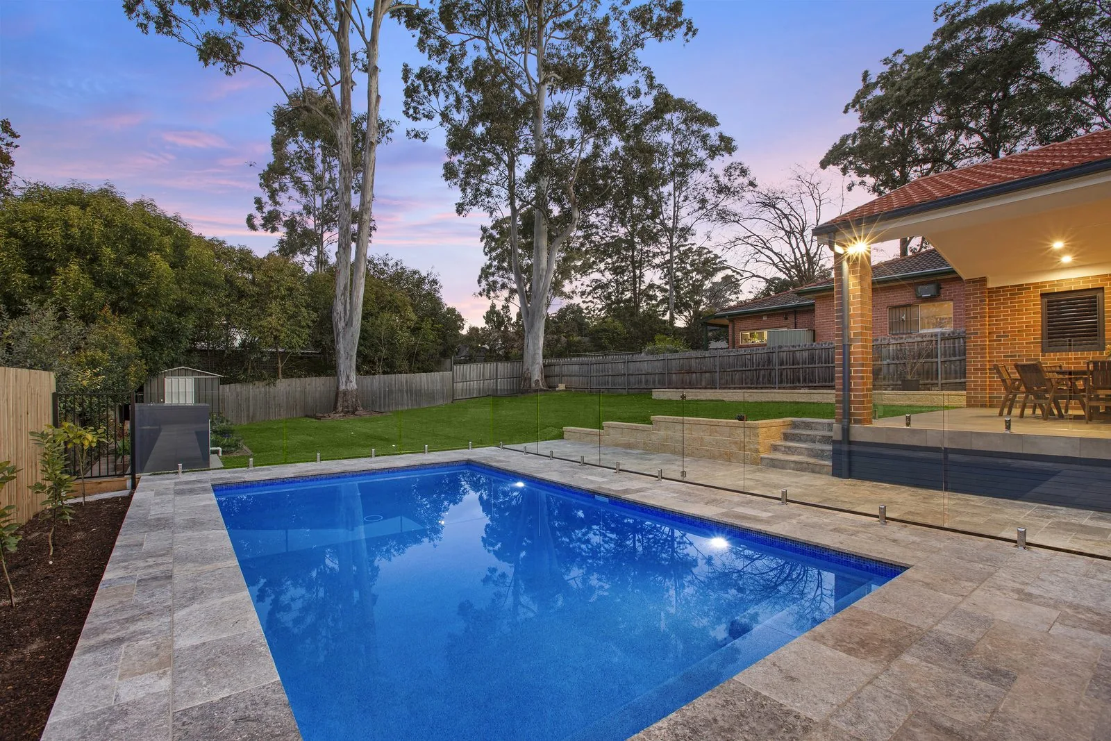 Concrete pool and landscaping at dusk, built by Refined Group in neighbouring Pennant Hills