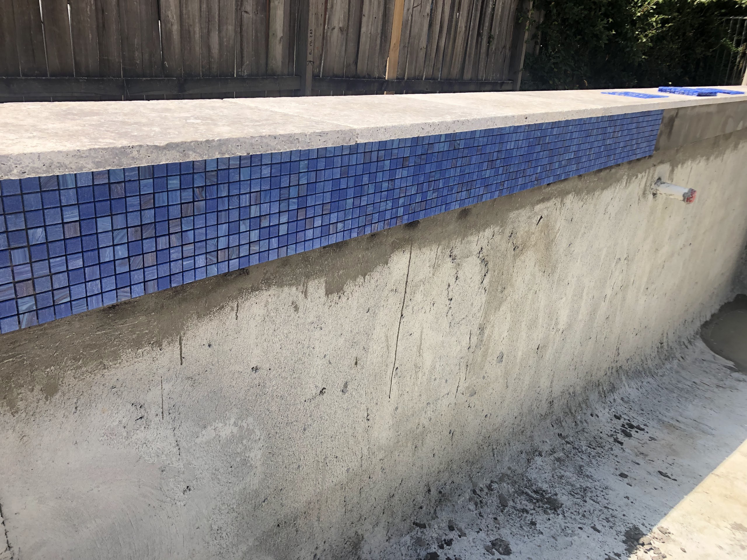 Stage two: the Bisazza mosaic waterline applied as the home build wound down