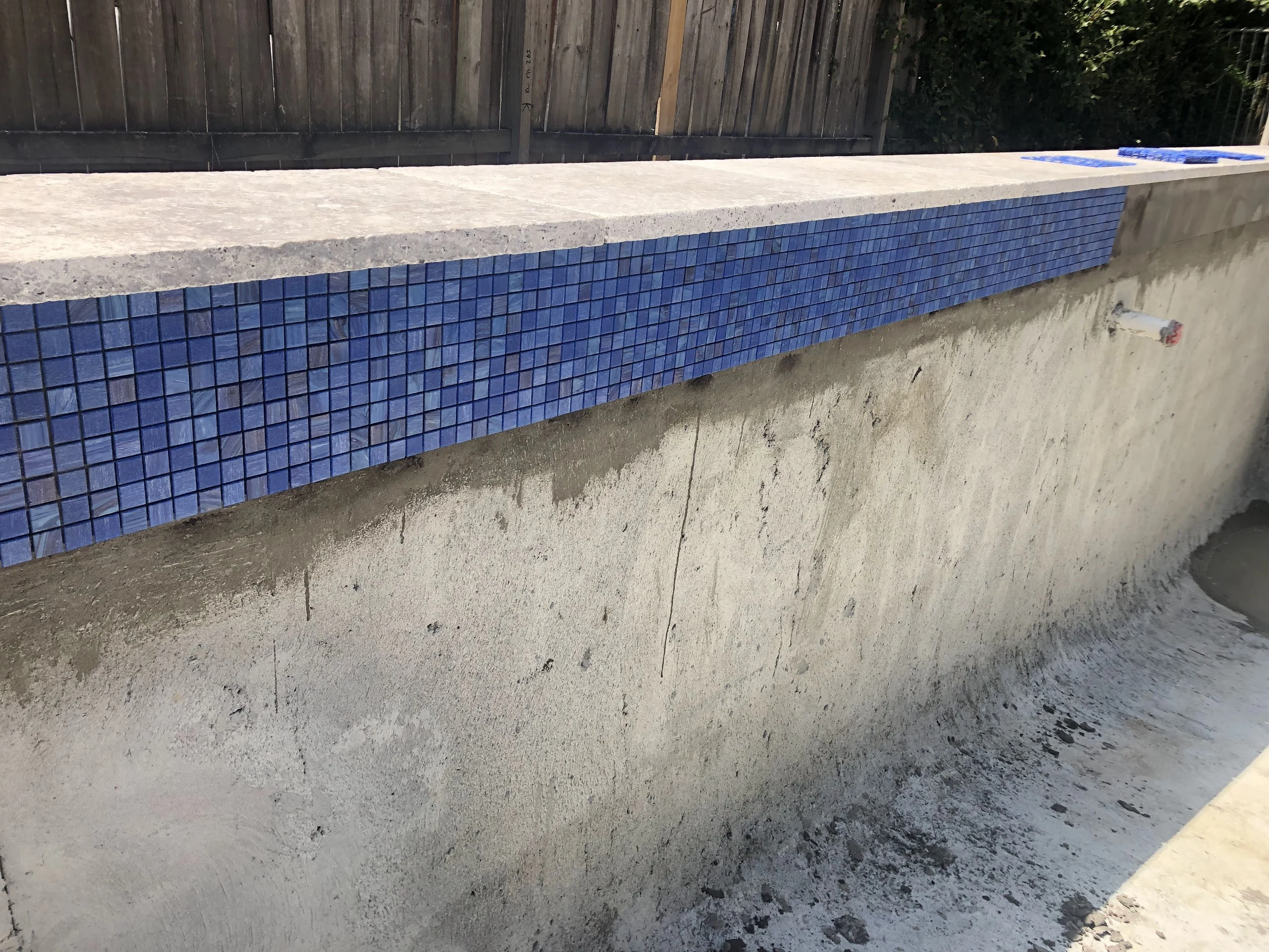 Stage two: the Bisazza mosaic waterline applied as the home build wound down