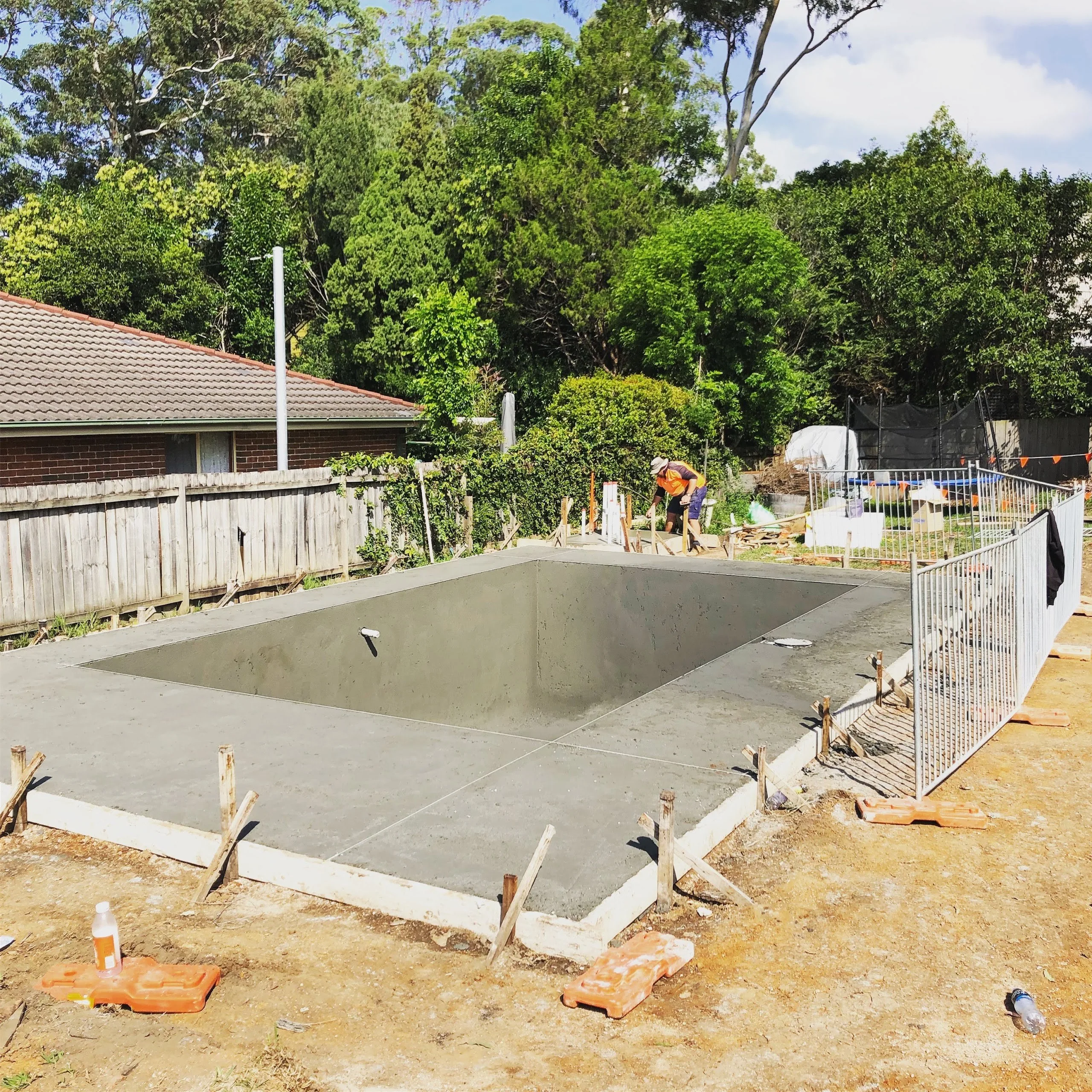 The finished concrete shell standing alone on the open block, waiting for the house