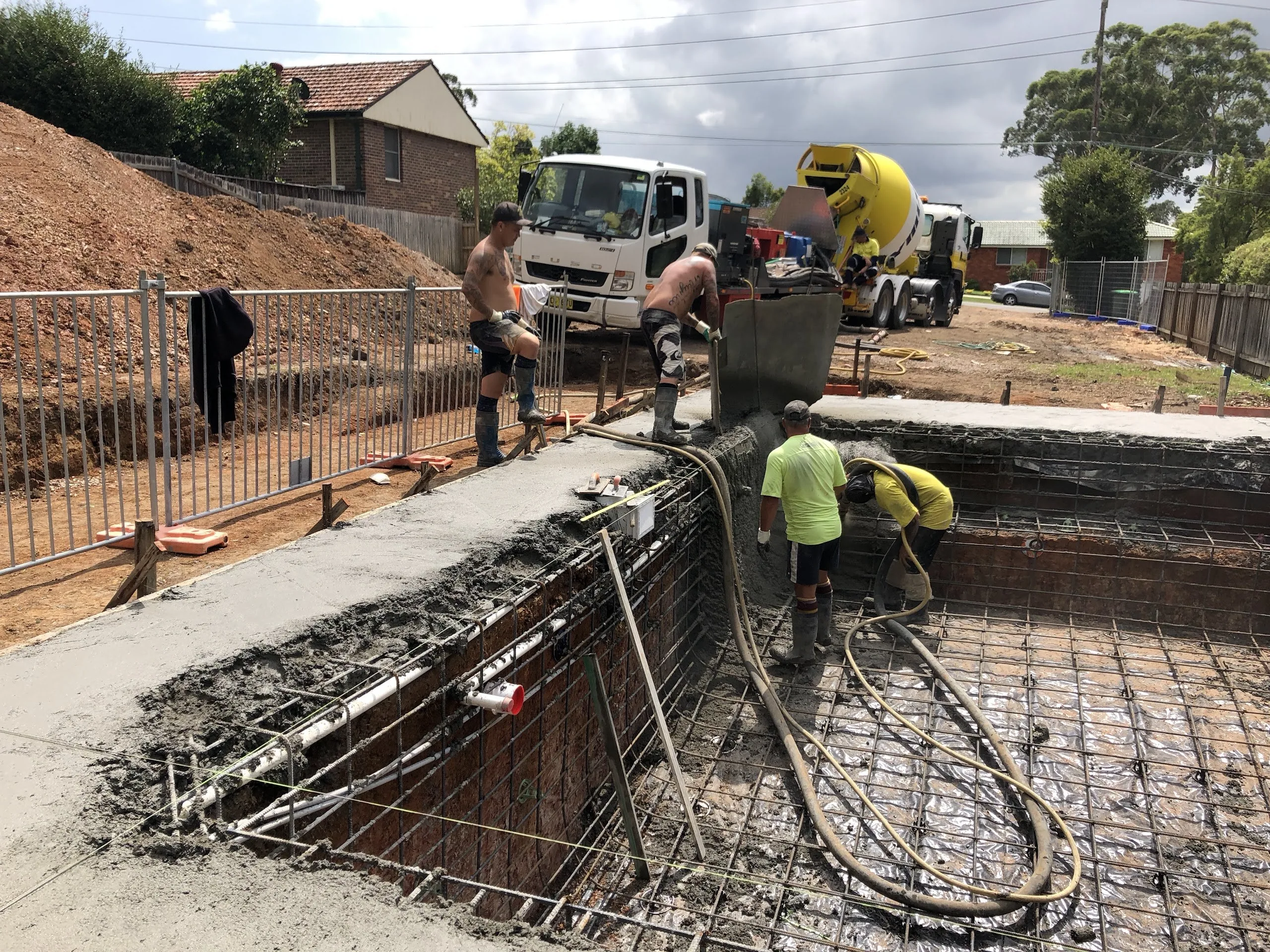Concrete spray day: the crew shooting the pool shell while the block was still open