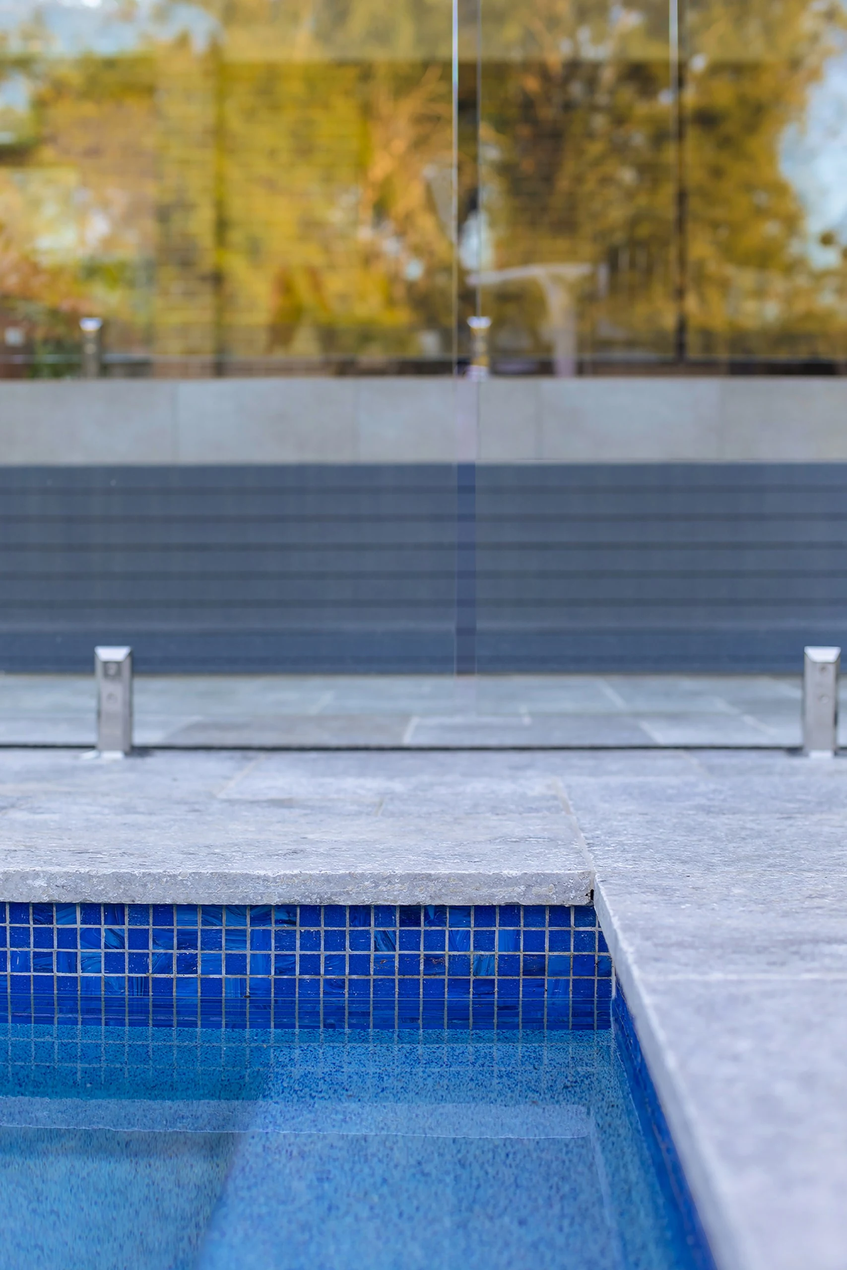 Bisazza glass mosaic waterline and travertine coping detail, Pennant Hills pool
