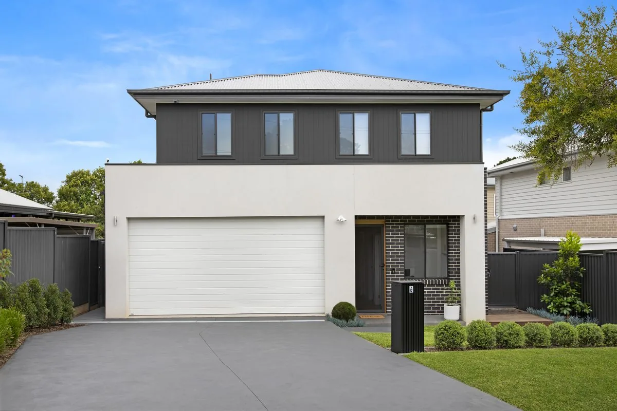 Dual occupancy home with white render and dark cladding, Seven Hills