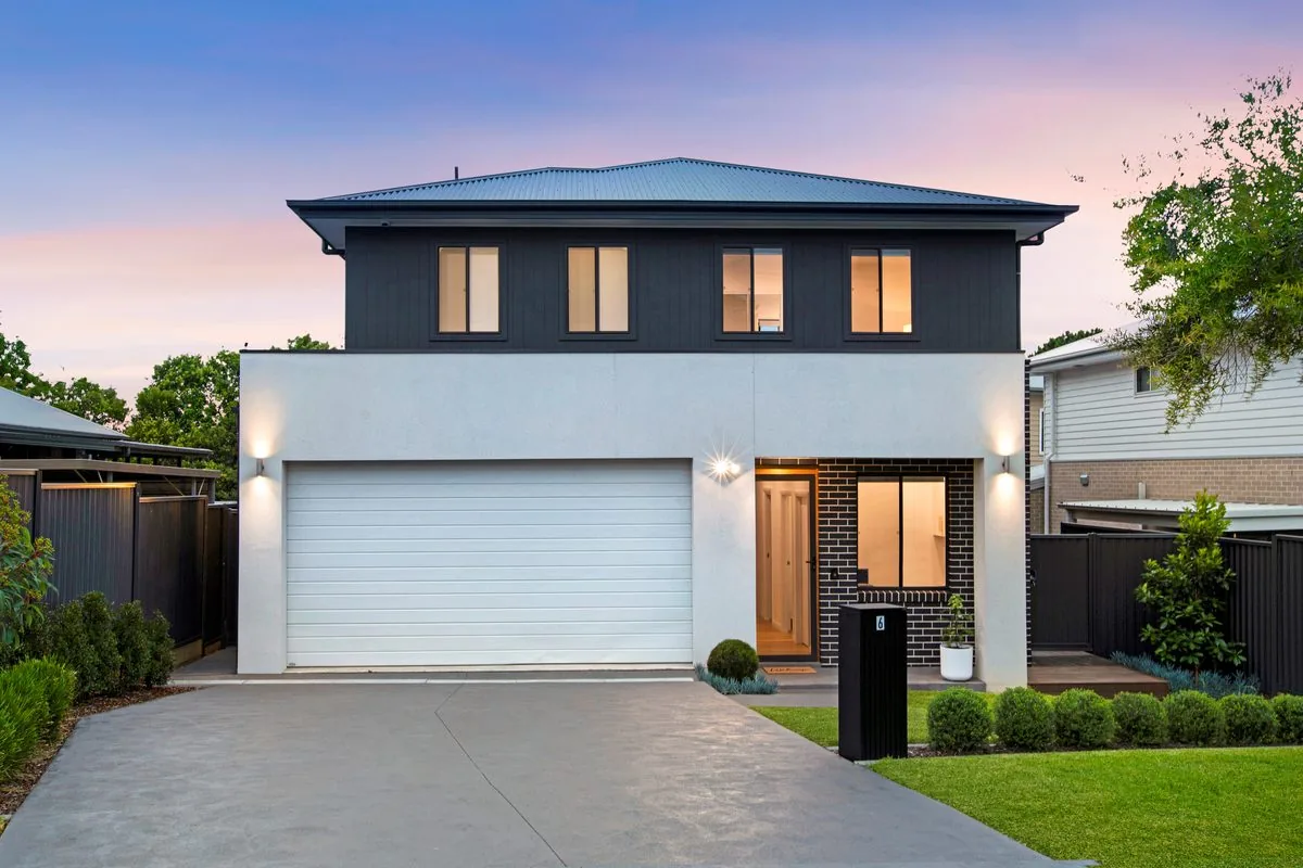 Dual occupancy home at dusk with lit facade, Seven Hills