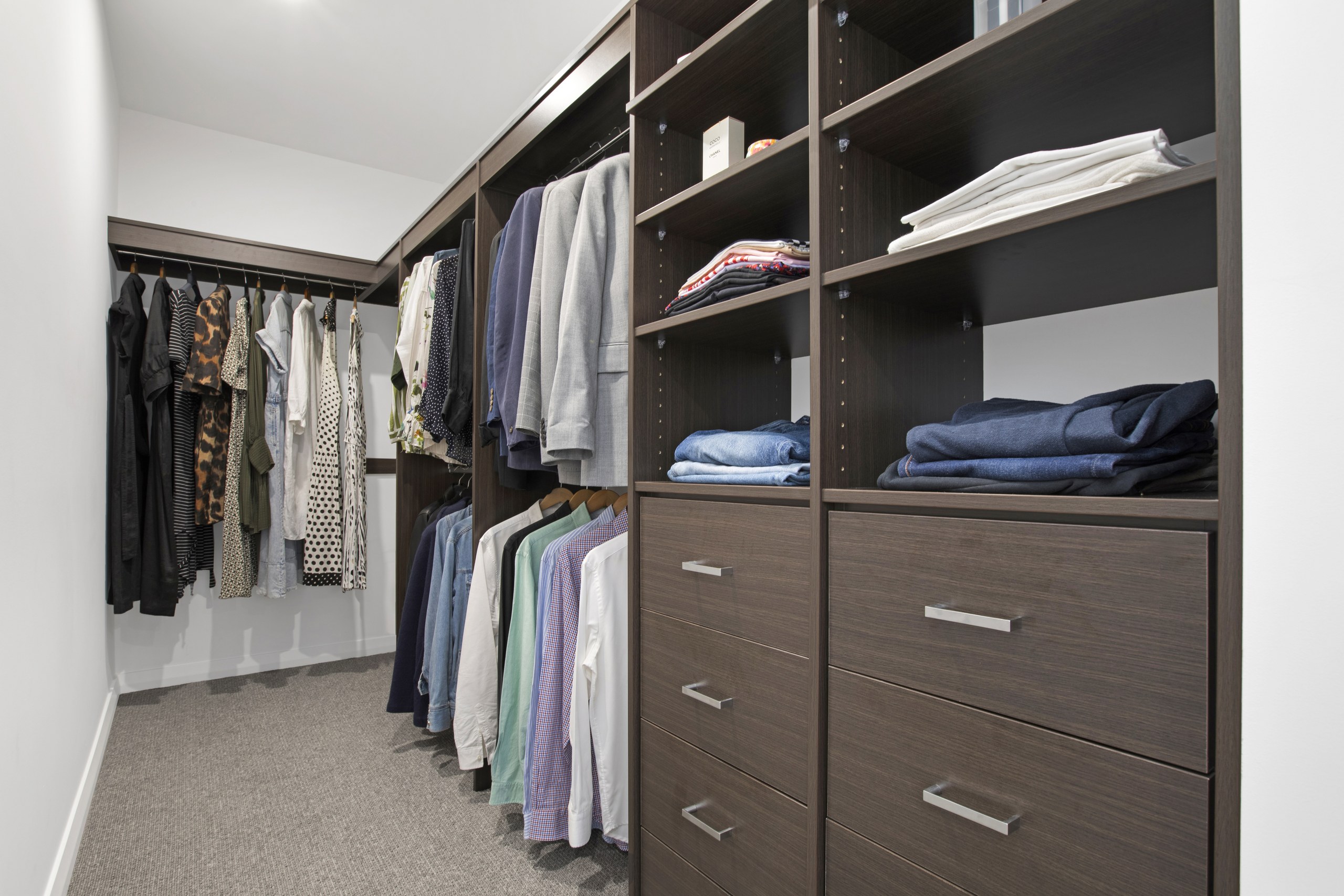 Fitted walk-in wardrobe with dark timber joinery, Seven Hills family home