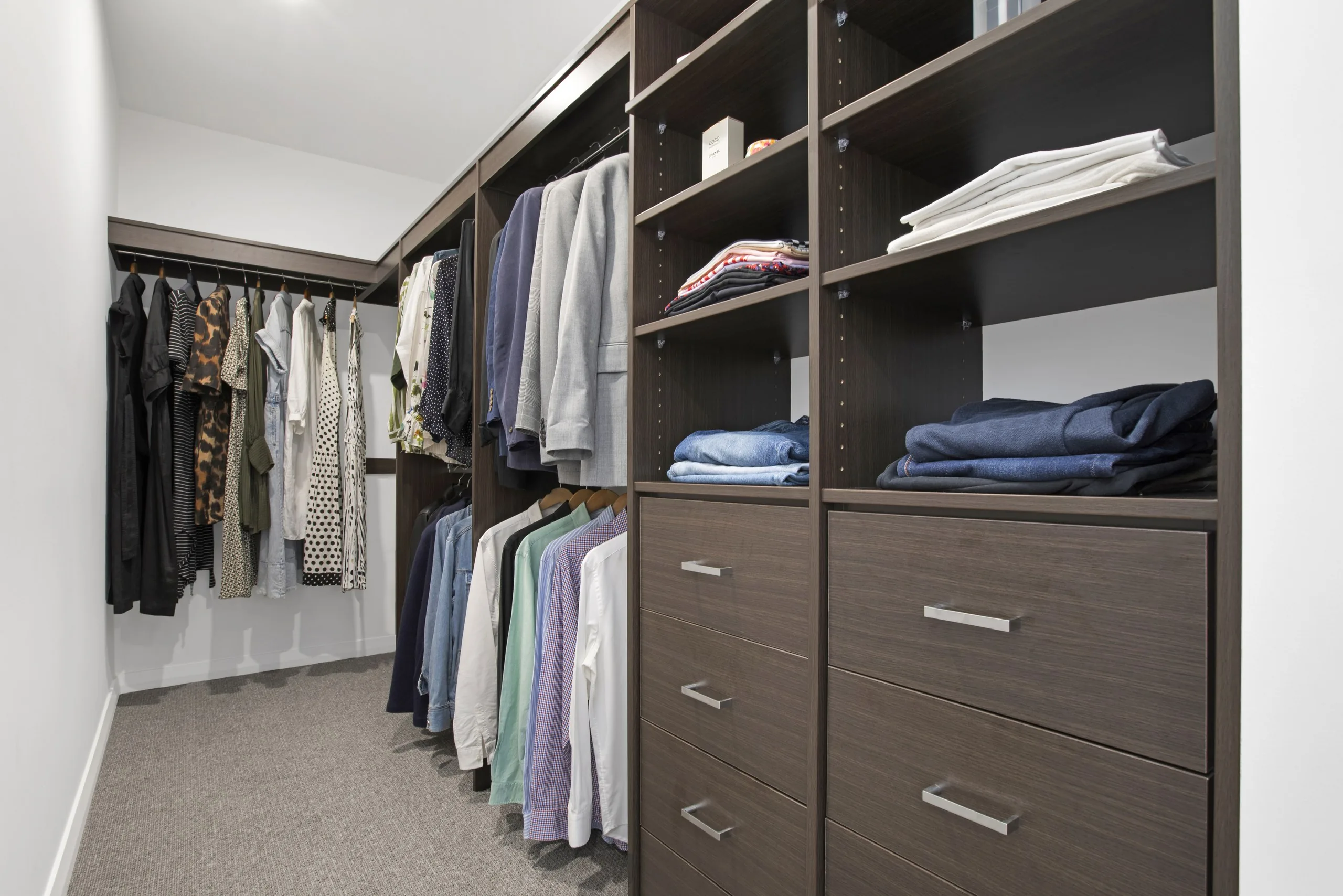 Fitted walk-in wardrobe with dark timber joinery, Seven Hills family home