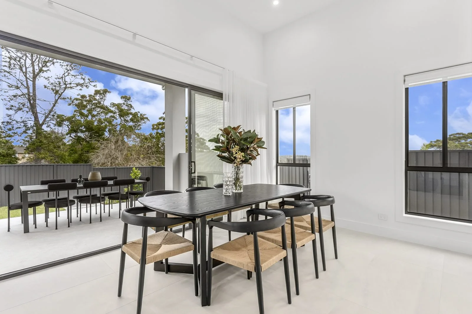 Dining space opening to a covered alfresco in a Refined Group custom home