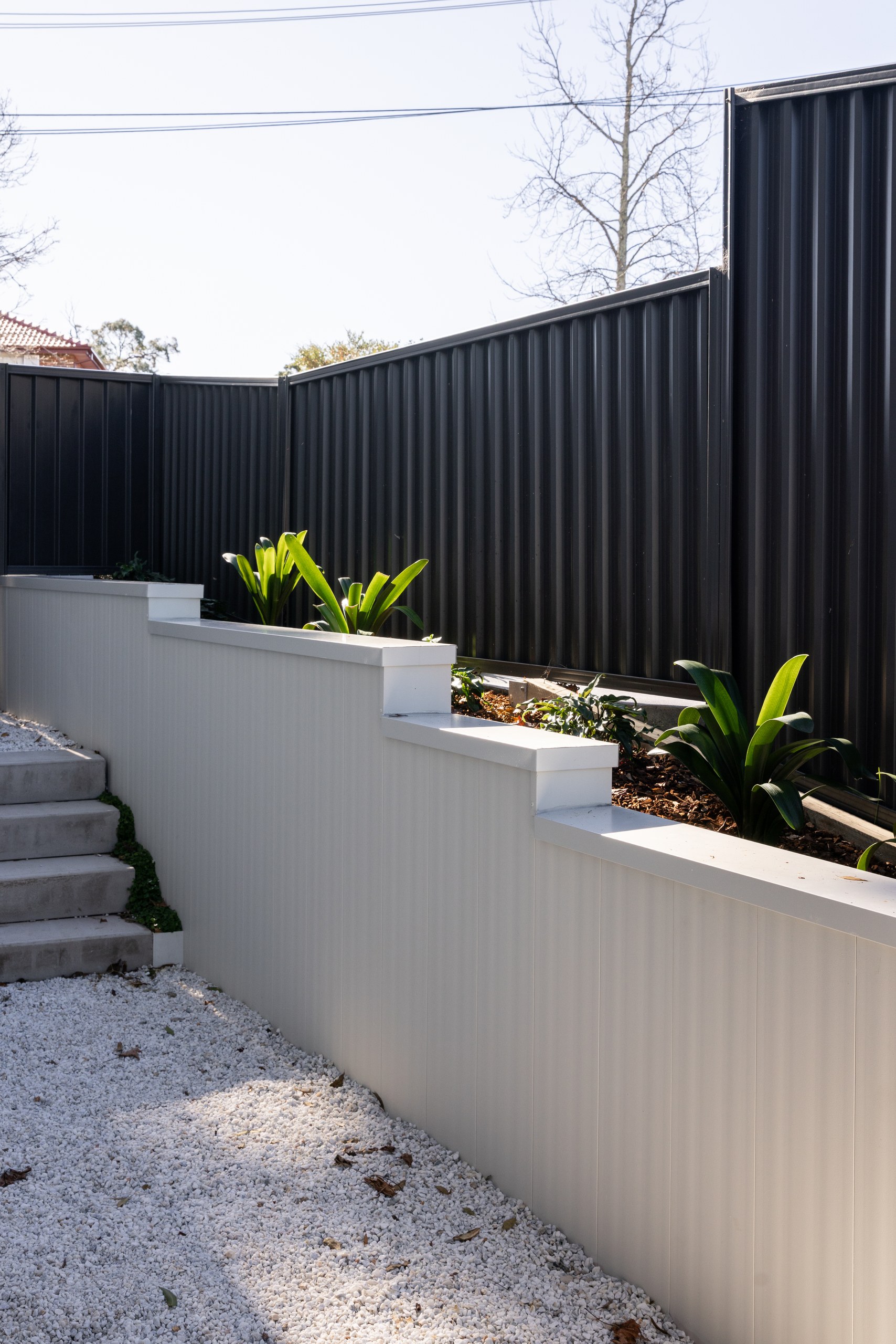 Terraced retaining walls with planting on the sloping block, Westleigh