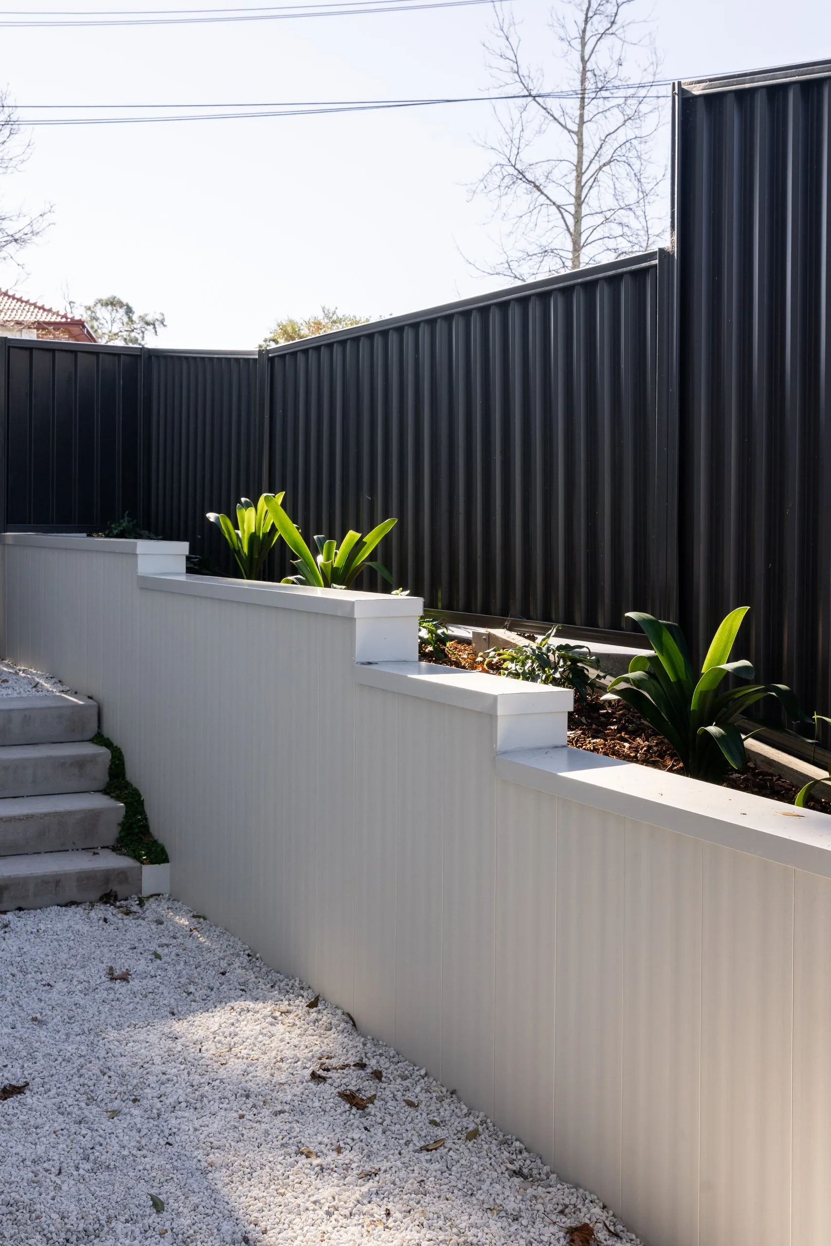 Terraced retaining walls with planting on the sloping block, Westleigh