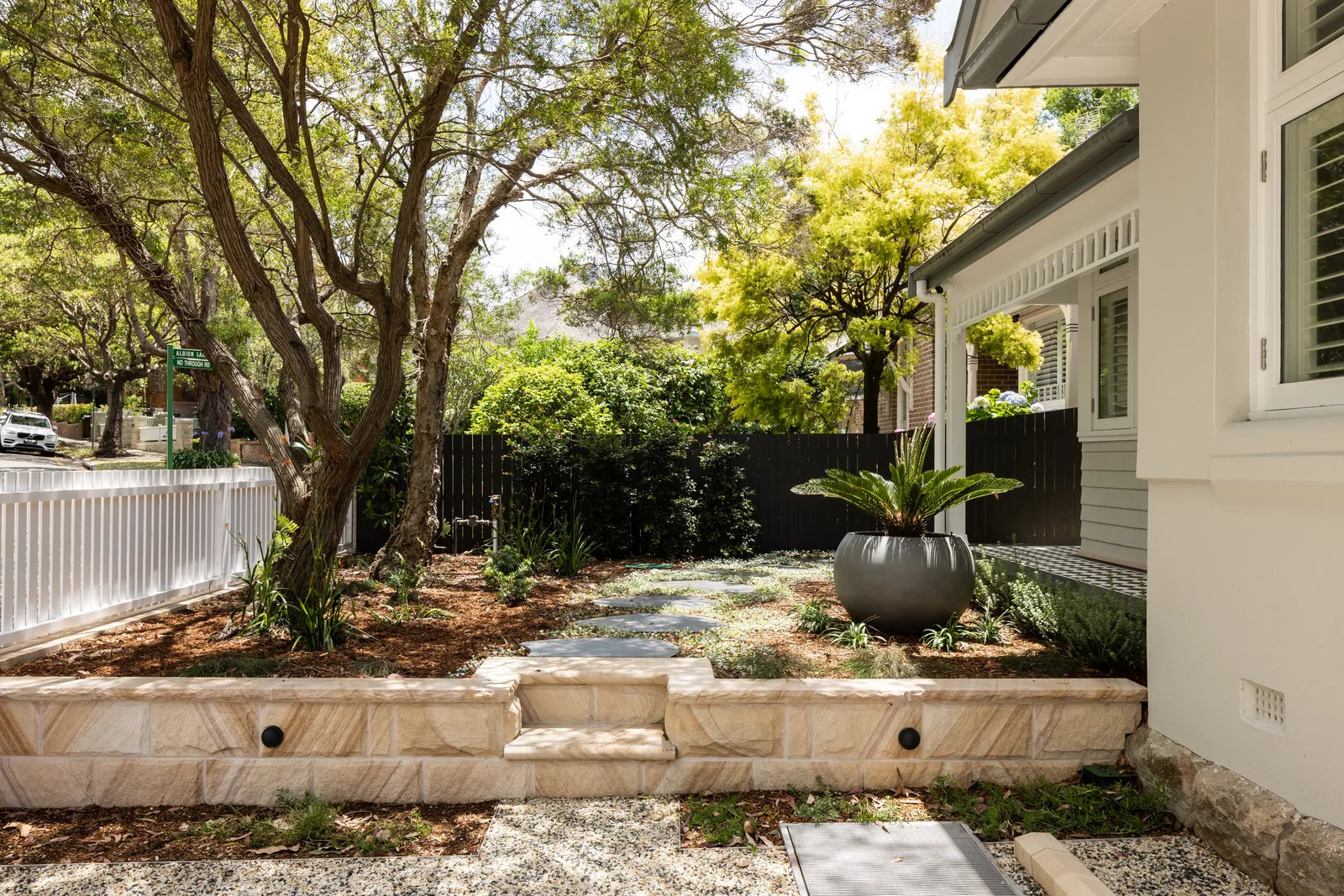 Sandstone retaining and planted front garden beside a character home, built by Refined Group in Mosman