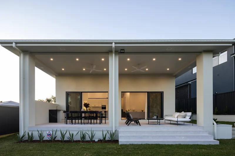 Covered alfresco lit at dusk, Westleigh custom home