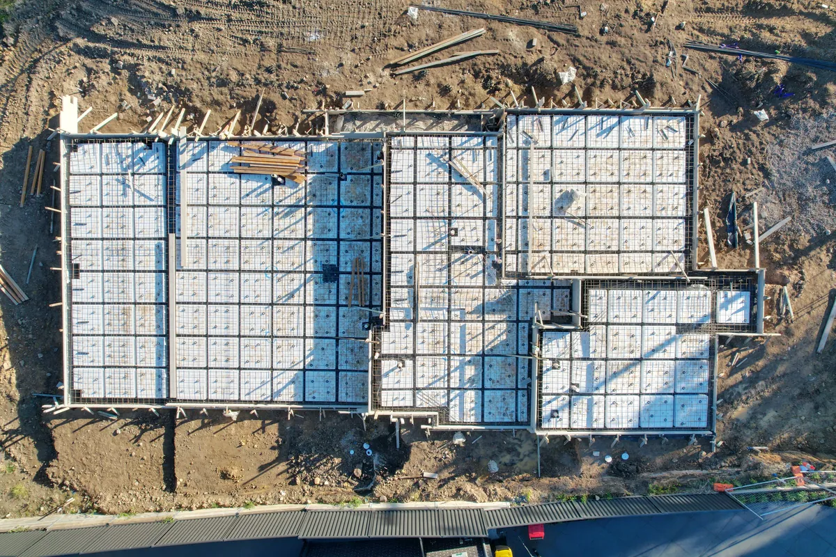 Looking straight down on a waffle pod slab with its steel in place, ready for the concrete pour, on a Refined Group home