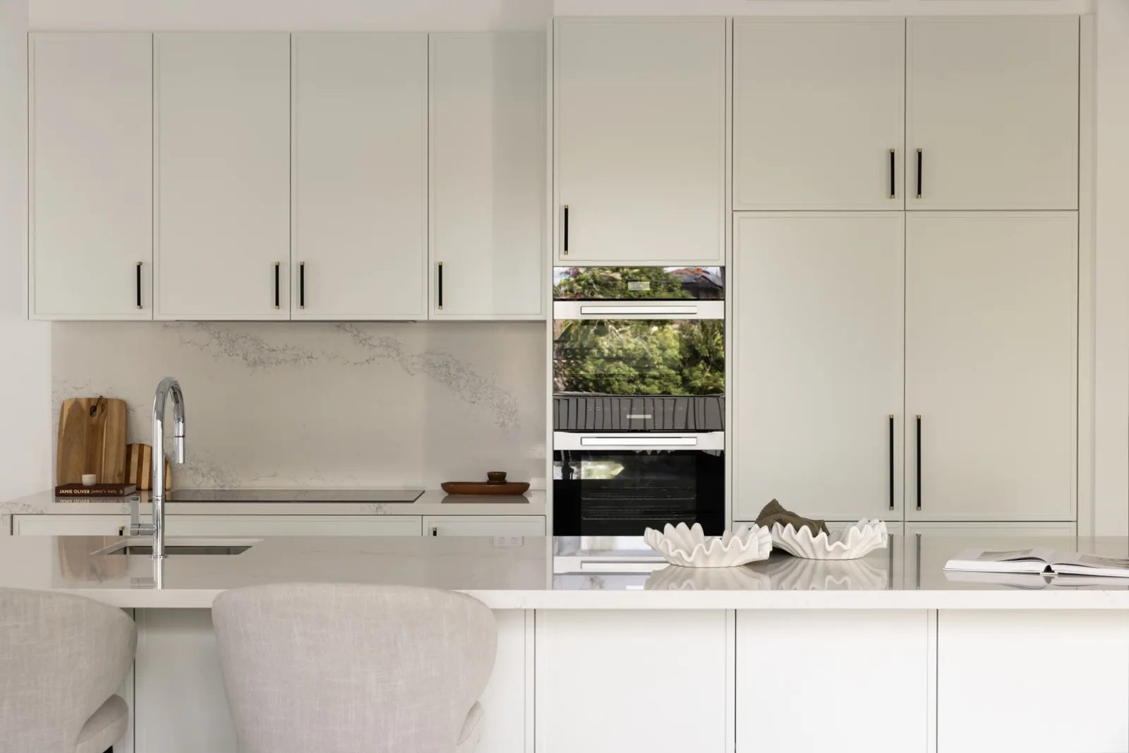 Kitchen with shaker joinery, stone splashback and Miele ovens in the Westleigh home built by Refined Group